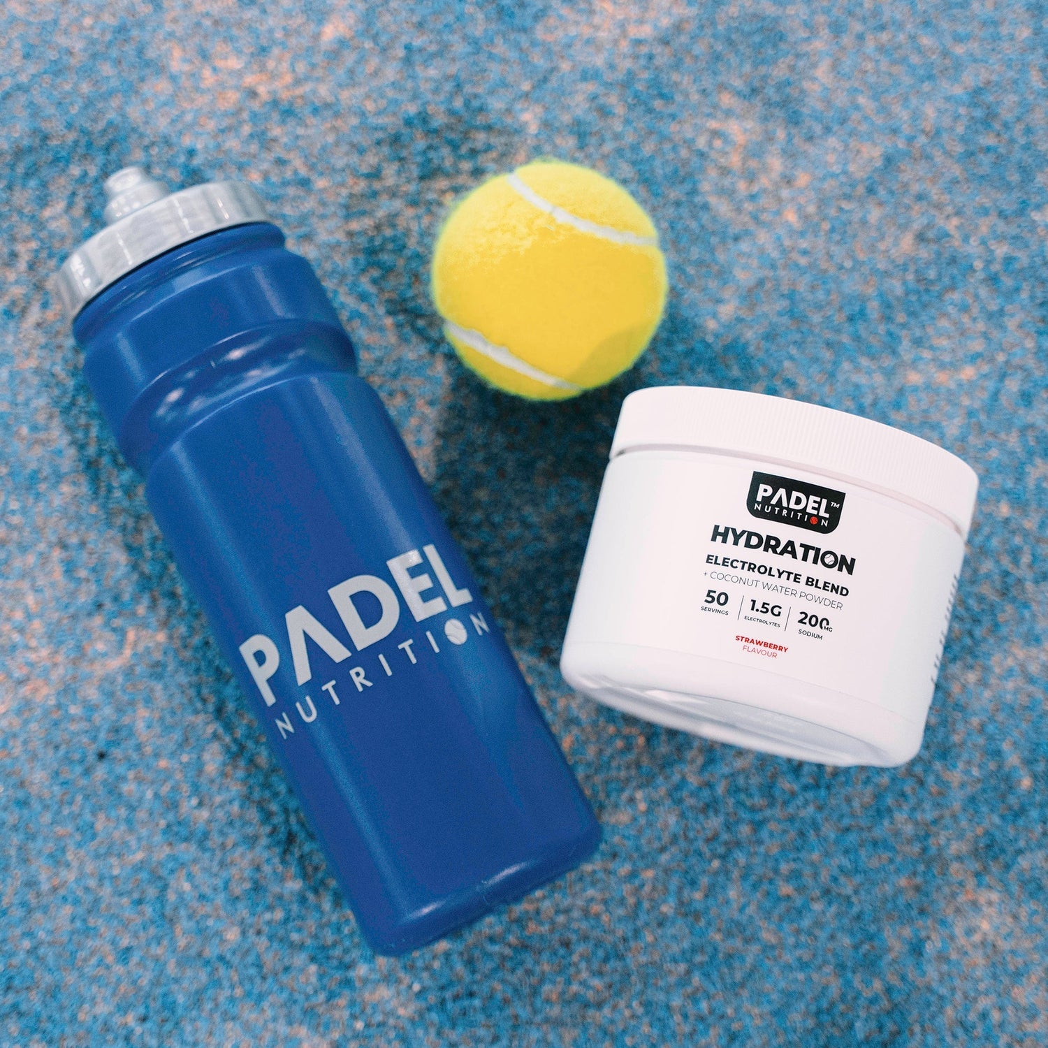 Electrolyte drink beside a padel racket on court