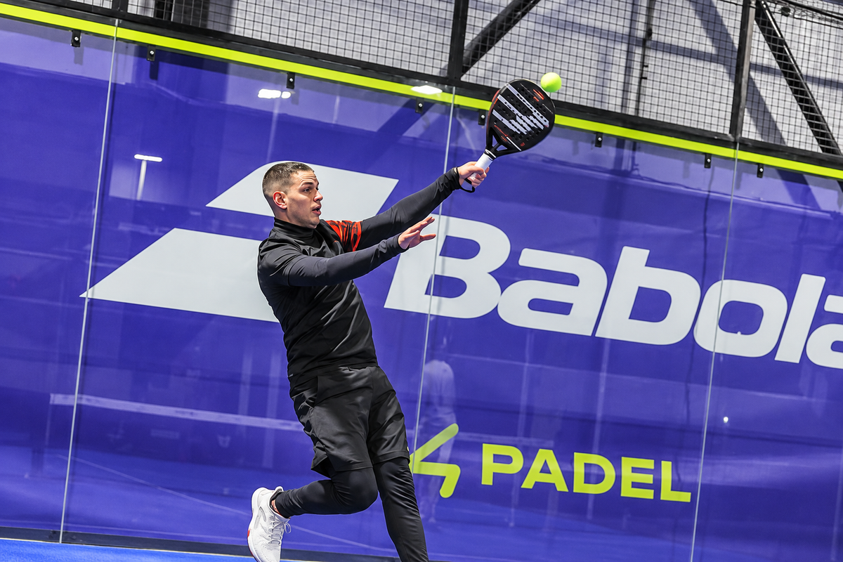 Former football player competing in a fast paced padel match